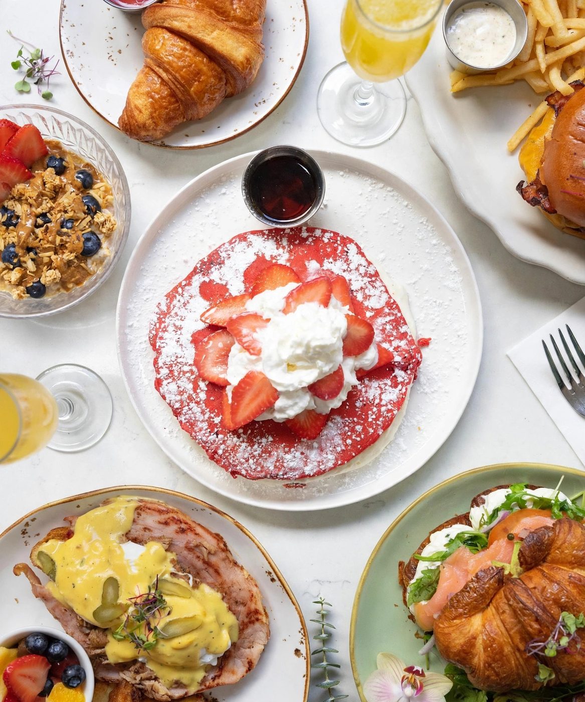 Morning spread at Wilde — pancakes, croissants, eggs Benedict and mimosas